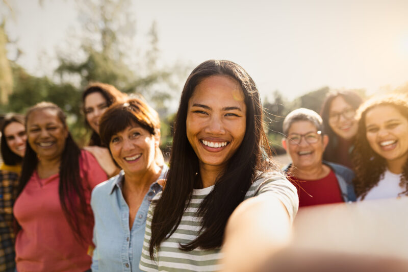 Happy, diverse group of people looking into camera